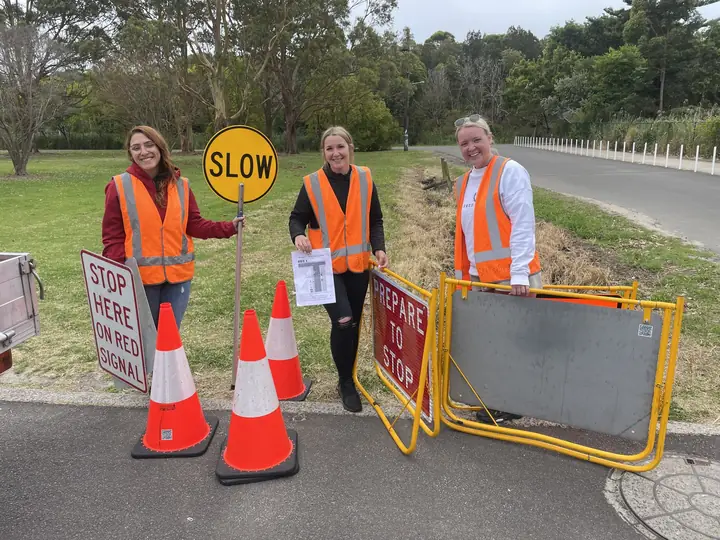 Students setting up traffic control signs and cones